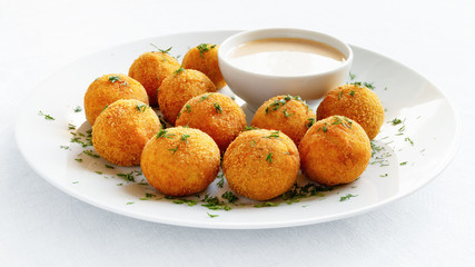 lentil fritters with hot pepers and yougurt based sauce decorated with dill