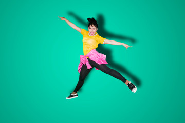 Fototapeta na wymiar Attractive female modern dancer jumping