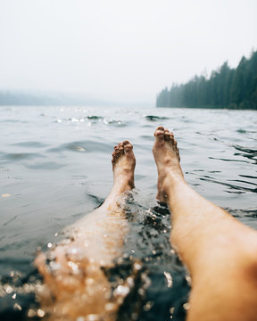 Low section of woman floating on water