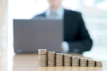 businessman typing on computer keyboard working . coins stack