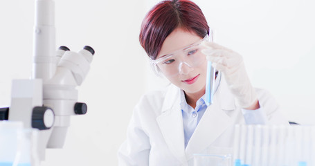 woman scientist take test tube