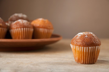 close-up of a muffin on the background of a plate with muffins, selective focus.