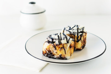 Cinnamon rolls with glaze on a plate. Fresh homemade cinnamon buns.