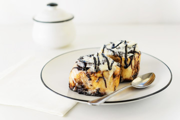 Cinnamon rolls with glaze on a plate. Fresh homemade cinnamon buns.
