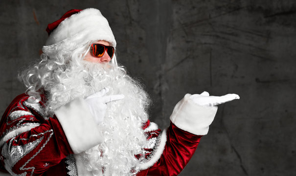 Santa Claus pointing hands at the corner for text copy space. New year and Merry Christmas
