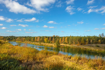 Autumn landscape with bright blue sky and river