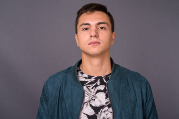 Fototapeta premium Studio shot of young handsome man against gray background