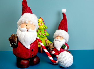 Santa Claus is playing golf with candy cane as golf club. Christmas and New Year holiday background concept. Copy space for text.