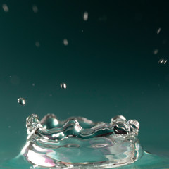 Drops of rain fall into the water, selective focus close-up