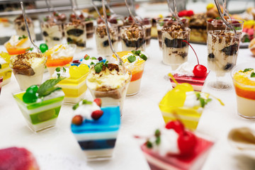 Modern desserts, cupcakes, sweets with fruits. Delicious candy bar. Catering Concept.
