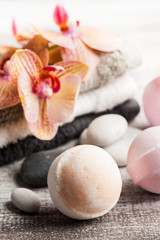 Spa still life with bath bombs and red orange orchid