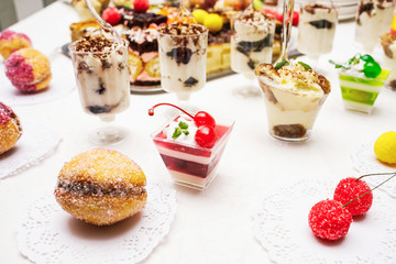 Modern desserts, cupcakes, sweets with fruits. Delicious candy bar. Catering Concept.