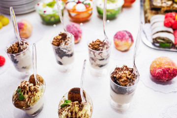 Modern desserts, cupcakes, sweets with fruits. Delicious candy bar. Catering Concept.