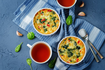 Spinach Red Bell Pepper Baked Omelet with cups of tea and fresh spinach leaves