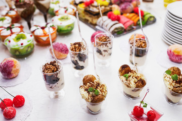 Modern desserts, cupcakes, sweets with fruits. Delicious candy bar. Catering Concept.
