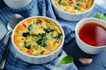 Spinach Red Bell Pepper Baked Omelet with cups of tea and fresh spinach leaves