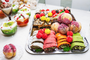 Modern desserts, cupcakes, sweets with fruits. Delicious candy bar. Catering Concept.