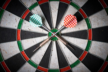 Crossed Darts On Dart Board. darts lie on dartboard