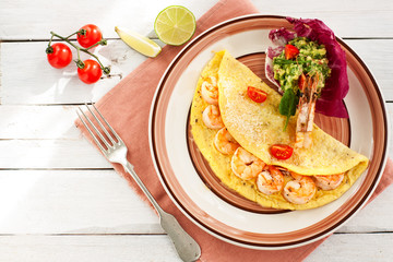 Omelette with shrimps and avocado salsa