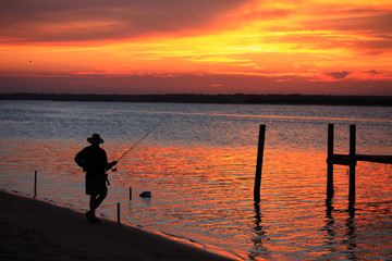 Fototapeta premium Fisherman awaiting his catch, Topsail Island, NC