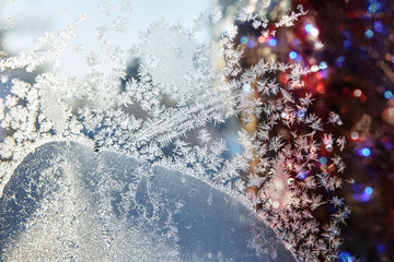  Multicolou .lights through the frozen window glass. Festive  Christmas background