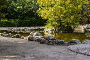 outdoor park space for walking and rest with small lake and island