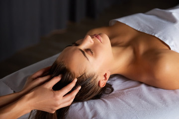 Fototapeta na wymiar Head and face massage in spa salon