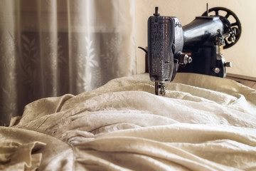 Vintage sewing machine making a traditional old bride dress in an italian home - obrazy, fototapety, plakaty