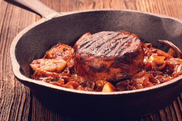 Fried pork chop with vegetable on wooden board