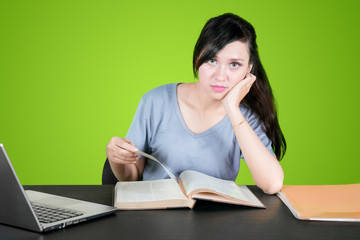 Student reading book and staring at camera
