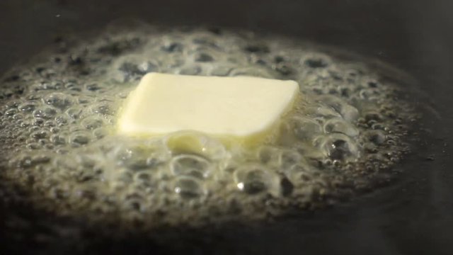 Slow motion butter melting preparing to cook and saut&eacute;. 