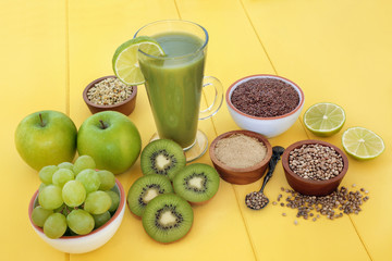 Healthy fruit juice smoothie drink with hemp powder, flax, chia and hemp seed with fresh fruit on yellow wood background. High in omega 3, antioxidants, vitamins and dietary fibre.