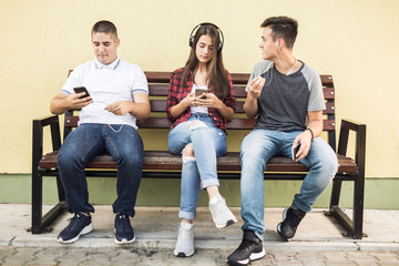 Group of teenagers having fun and listening to music