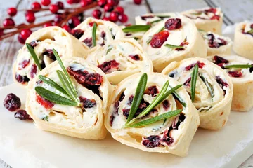 Fototapeten Cranberry, cream cheese pinwheel appetizers. Holiday food concept. Close up, on a white background. © Jenifoto