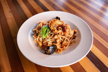 Seafood Pasta in white bowl on wooden table