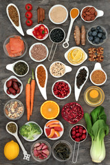 Food selection to slow the ageing process concept with super foods very high in antioxidants, anthocyanins, dietary fibre and vitamins. Top view on marble background.
