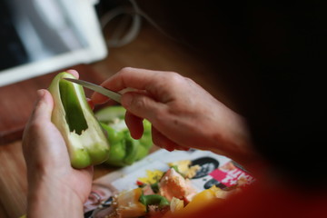 woman cutting vegetables in kitchen
