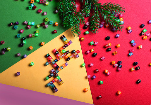 Crossword, letters of the English alphabet. Words on the theme of Christmas and New Year. The concept of a holiday or a day off. Abstract background, purple, pink, green, paper texture.