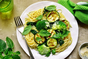 Spaghetti pasta with green vegetables (broccoli, spinach, grilled zucchini) .Top view.