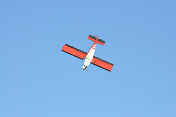 Small plane with propeller on blue sky