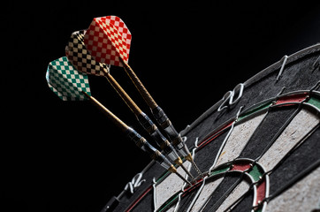 darts. 3 darts in triple 20. Black background