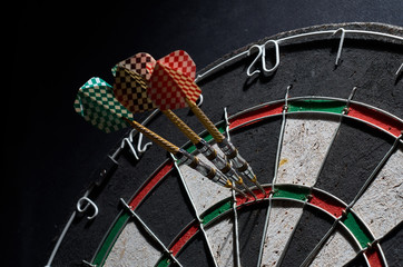 darts. 3 darts in triple 20. Black background