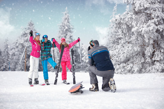 taking photographing of family on winter vacation in snow mountains