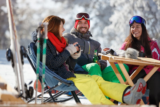 Female and male on skiing enjoy in cafe