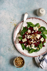 Autumn beetroot salad with spinach, feta cheese and walnuts.Top view.