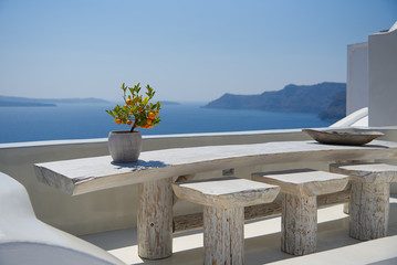 Fototapeta na wymiar Terrace with table on the sea ( Oia ) - Santorini Island - Aegean sea - Greece