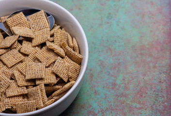 Breakfast cereal in white bowl on granite background