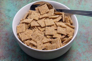 Breakfast cereal in white bowl on grunge background