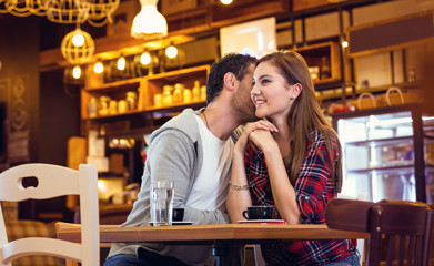 young couple smiling in coffee shop
