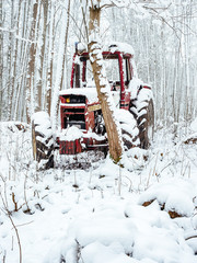 Abandoned tractor in the snow, pollution